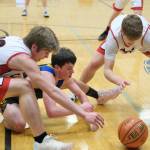 Klawock junior Connor Bagby (10) and Tristin Ryno go for a loose ball with Skagway senior Landon Rodig during Thursday action at the 2025 Alaska Airlines Region V 1A Boys Basketball Tournament at Thunder Mountain Middle School. (Klas Stolpe / Juneau Empire)