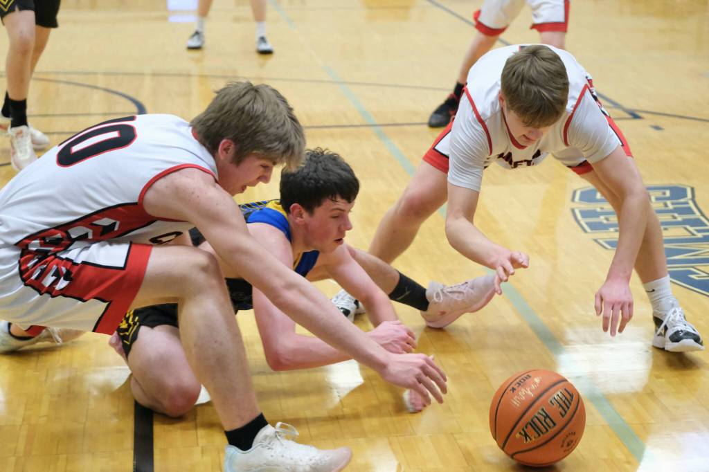 Klawock junior Connor Bagby (10) and Tristin Ryno go for a loose ball with Skagway senior Landon Rodig during Thursday action at the 2025 Alaska Airlines Region V 1A Boys Basketball Tournament at Thunder Mountain Middle School. (Klas Stolpe / Juneau Empire)