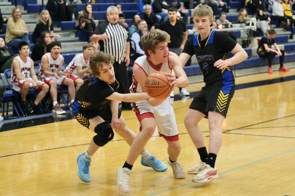 Klawock junior Connor Bagby (10) is pressured by Skagway junior Kaleb Cochran and sophomore Malcolm Lawson (3) during Thursday action at the 2025 Alaska Airlines Region V 1A Boys Basketball Tournament at Thunder Mountain Middle School. (Klas Stolpe / Juneau Empire)