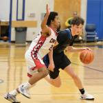Klawock freshman Dahani Peel (23) defends junior Royce Borst (4) during Thursday action at the 2025 Alaska Airlines Region V 1A Boys Basketball Tournament at Thunder Mountain Middle School. (Klas Stolpe / Juneau Empire)