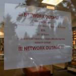 A sign posted on the door of AT&T in Juneau on Friday estimates the outage will be fixed by noon on Saturday, March 1, 2025. (Jasz Garrett / Juneau Empire)