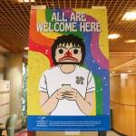A poster designed by Chloey Cavanaugh, an Indigenous and queer Juneau business owner, is found around campus with the words all are welcome here. (Jasz Garrett / Juneau Empire)