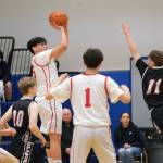 Kake's Devin Aceveda shoots over Klawock's Thomas Teal (11) in the Thunderbirds’ 56-40 win over the Chieftains on Friday during the 2025 Alaska Airlines Region V 1A Boys Basketball Tournament Championship game at Thunder Mountain Middle School. (Klas Stolpe / Juneau Empire)