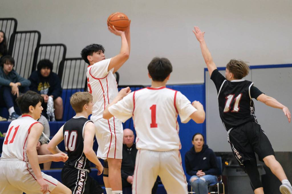 Kake's Devin Aceveda shoots over Klawock's Thomas Teal (11) in the Thunderbirds’ 56-40 win over the Chieftains on Friday during the 2025 Alaska Airlines Region V 1A Boys Basketball Tournament Championship game at Thunder Mountain Middle School. (Klas Stolpe / Juneau Empire)