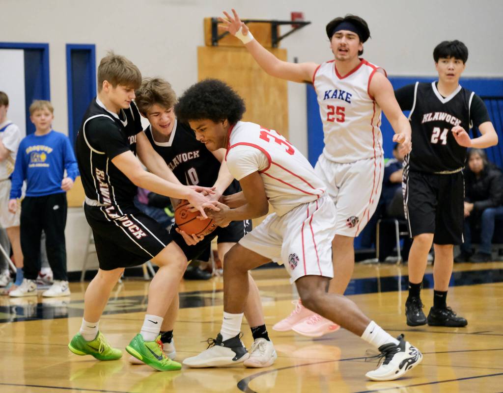 Klawock's Tristine Ryno and Connor Bagby fight for a loose ball with Kake's Keontay Jackson (33) during the Chieftains’ 56-40 loss to the Thunderbirds on Friday in the the 2025 Alaska Airlines Region V 1A Boys Basketball Tournament Championship game at Thunder Mountain Middle School. (Klas Stolpe / Juneau Empire)