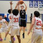 Klawock's Tanner Smith (00) shoots over Kake's Wyatt Kadake (42), Keontay Jackson (33) and Aiden Clark (25) during the Chieftains’ 56-40 loss to the Thunderbirds on Friday in the the 2025 Alaska Airlines Region V 1A Boys Basketball Tournament Championship game at Thunder Mountain Middle School. (Klas Stolpe / Juneau Empire)