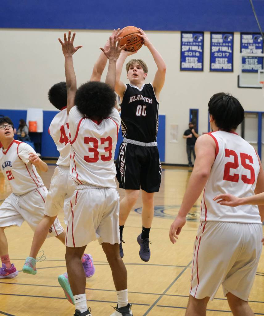 Klawock's Tanner Smith (00) shoots over Kake's Wyatt Kadake (42), Keontay Jackson (33) and Aiden Clark (25) during the Chieftains’ 56-40 loss to the Thunderbirds on Friday in the the 2025 Alaska Airlines Region V 1A Boys Basketball Tournament Championship game at Thunder Mountain Middle School. (Klas Stolpe / Juneau Empire)