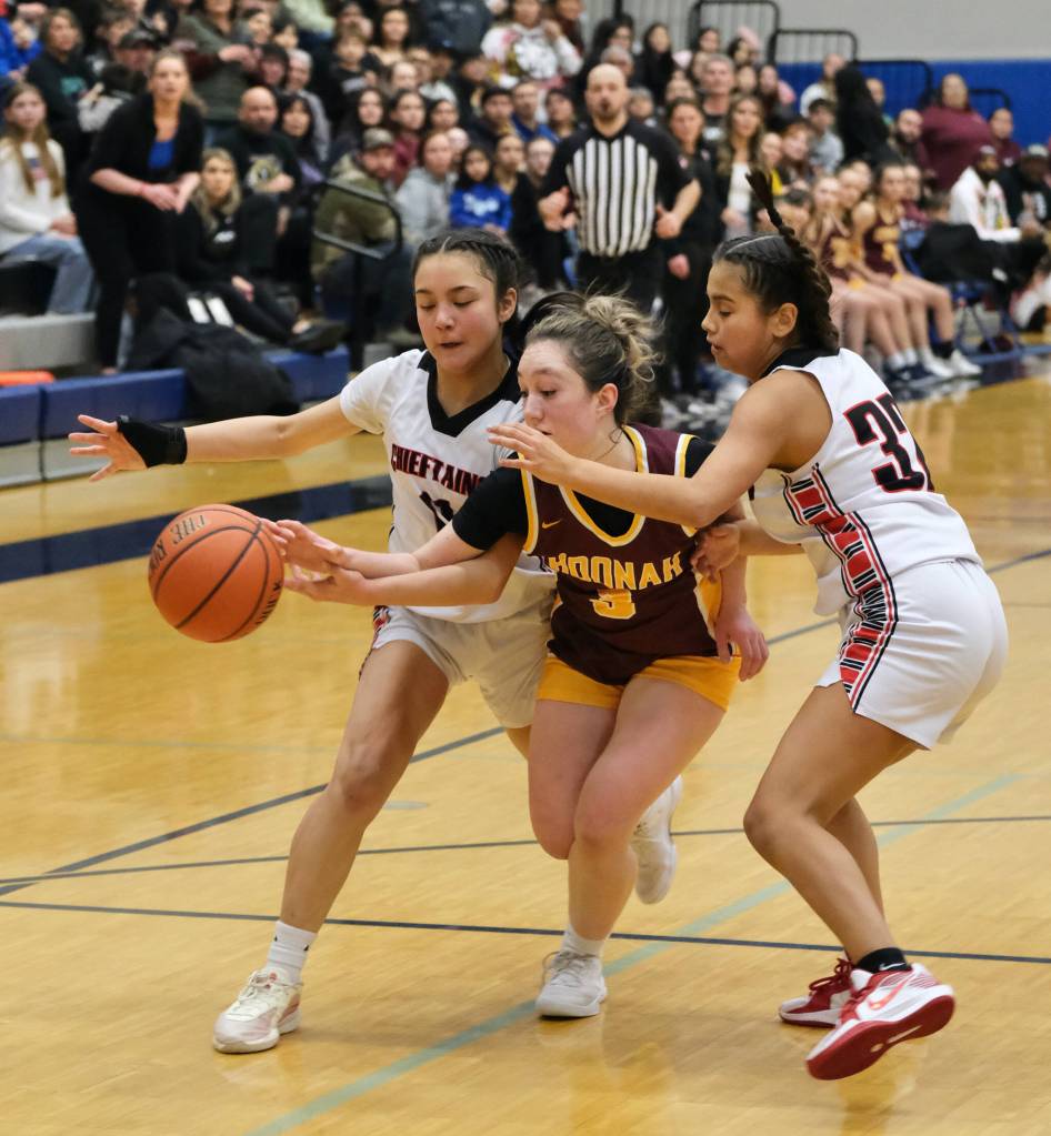 Klawocks Jayla Edenshaw (11) and Keira Sanderson (32) defend Hoonahs Jora Savland (3) during the Chieftains 34-33 win over the Braves on Friday during the 2025 Region V 1A Girls Basketball Championship game at Thunder Mountain Middle School. (Klas Stolpe / Juneau Empire)