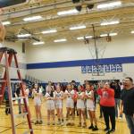 Klawocks Lea Armour (23) cuts down the net as teammates look on after the Chieftains defeated the Hoonah Braves 34-33 for the Region V 1A Girls Basketball Championship on Friday at Thunder Mountain Middle School. (Klas Stolpe / Juneau Empire)