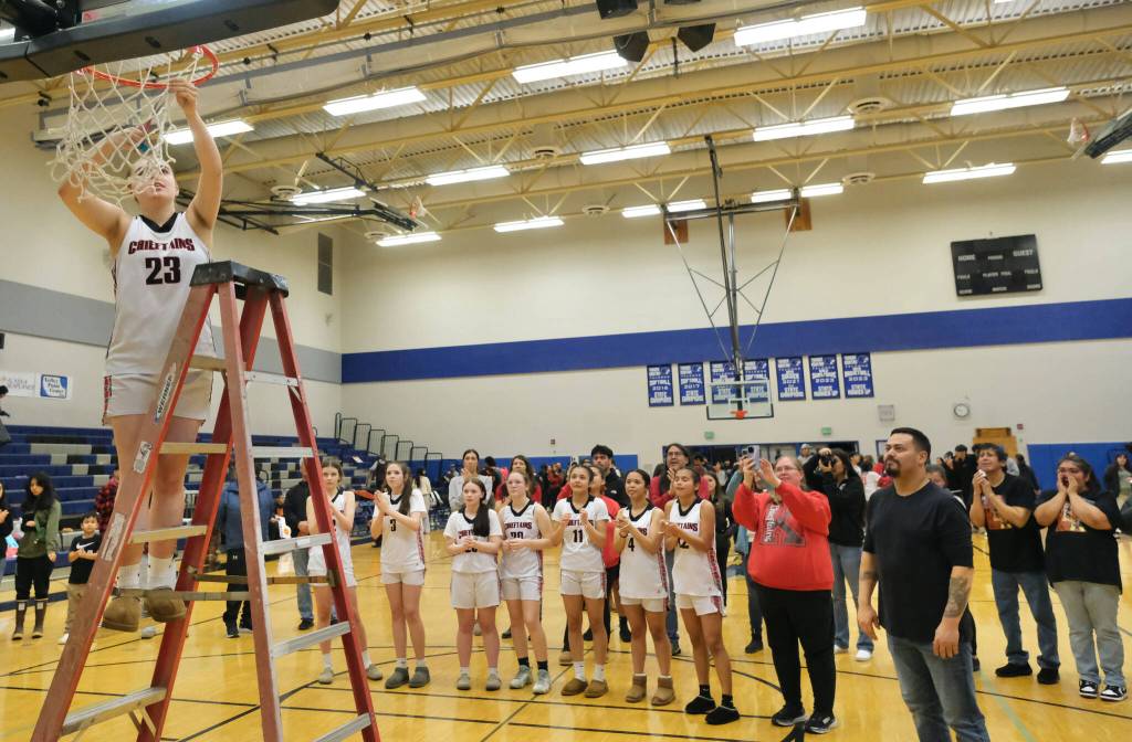 Klawocks Lea Armour (23) cuts down the net as teammates look on after the Chieftains defeated the Hoonah Braves 34-33 for the Region V 1A Girls Basketball Championship on Friday at Thunder Mountain Middle School. (Klas Stolpe / Juneau Empire)