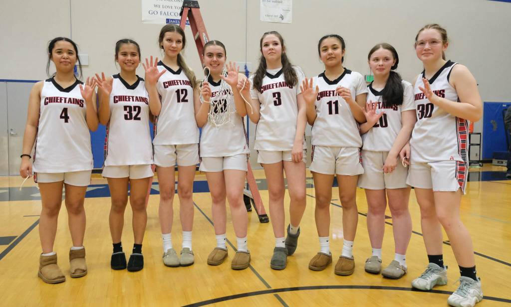 Klawock Chieftains Layla Gregory (4), Keira Sanderson (32), Kaiya Marvin (12), Lea Armour (23), AnaRose Peratrovich (3), Jayla Edenshaw (11), Kendra Yates (20) and Alli Demmert (30) pose after defeating the Hoonah Braves 34-33 for the Region V 1A Girls Basketball Championship on Friday at Thunder Mountain Middle School. (Klas Stolpe / Juneau Empire)