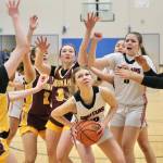 Klawocks Kaiya Marvin (12) sets to power up a shot under pressure from Hoonahs Paige Woitte (13), Jenna Jack (2), Jora Savland (3) and Nevaeh Campbell during the Chieftains 34-33 win over the Braves during 2025 Region V 1A Girls Basketball Tournament Championship game Friday at Thunder Mountain Middle School. (Klas Stolpe / Juneau Empire)