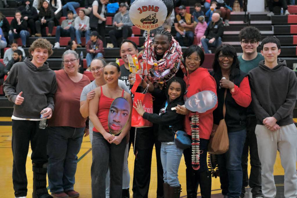 Friends and family of Juneau-Douglas High School: Yadaa.at Kalé Crimson Bears senior Ahmir Parker during Senior Night honors Saturday at the George Houston Gymnasium. (Klas Stolpe / Juneau Empire)