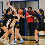 Hoonahs Jora Savland (3) is swarmed on a shot by Skagways Amelia Myers, Kelsey Cox and Lennon Jennings (21) during Saturdays Region V 1A Girls Basketball Tournament Runner-Up game at Thunder Mountain Middle School. (Klas Stolpe / Juneau Empire)