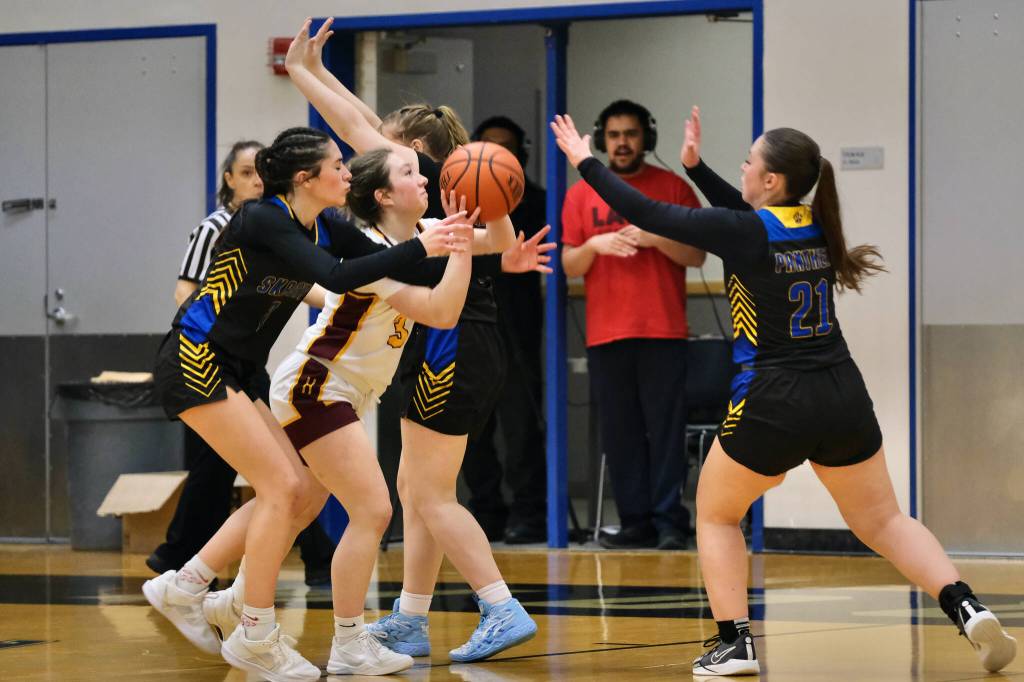 Hoonahs Jora Savland (3) is swarmed on a shot by Skagways Amelia Myers, Kelsey Cox and Lennon Jennings (21) during Saturdays Region V 1A Girls Basketball Tournament Runner-Up game at Thunder Mountain Middle School. (Klas Stolpe / Juneau Empire)