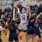 Juneau-Douglas High School: Yadaa.at Kalé senior Kerra Baxter (22) scores against North Pole last weekend as sophomore Bergen Erickson (12) looks on. The Crimson Bears open the 2A/4A Region V tournament against Kayhi at 6 p.m. Thursday in Ketchikan's Clarke Cochran Gymnasium. (Klas Stolpe / Juneau Empire)