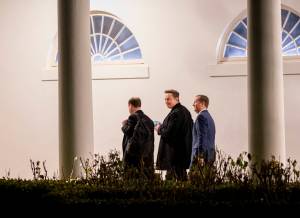 Elon Musk walks with senior staff after arriving with President Donald Trump on Marine One on the South Lawn of the White House in Washington, Feb. 19, 2025. (Doug Mills/The New York Times)