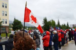 A Whitehorse resident wears a Canadian flag in her hair during the annual Canada Day parade on July 1, 2023, in Whitehorse, Yukon. (James Brooks/Alaska Beacon)