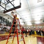 Juneau-Douglas High School: Yadaa.at Kalé coach Tanya Nizich cuts down the net after their 65-43 victory over Kayhi, winning the Region V 4A Basketball Tournament at the Clarke Cochrane Gymnasium on Friday. Juneau-Douglas eliminated Kayhi and will advance to play at state. (Christopher Mullen / Ketchikan Daily News)