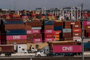 Trucks haul shipping containers and other cargo through the terminal at the Port of Los Angeles, in San Pedro, Calif., Feb. 14, 2025. President Donald Trump said that Americans would be better off in the long run from his tariffs, which he said would prevent the country from being ripped off. (Mark Abramson/The New York Times)