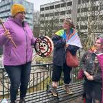 Daaljíni Mary Cruise, left, offers encouragement to participants in a Unity for the Queer Community rally at the Alaska State Capitol on Sunday afternoon. (Mark Sabbatini / Juneau Empire)