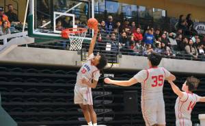 Kakes Keontay Jackson (33) attempts a dunk during the Thunderbirds 61-41 win over the King Cove T-Jacks in the 2025 ASAA March Madness Alaska 1A/2A State Basketball Championships on Wednesday at Anchorages Alaska Airlines Center (Klas Stolpe / Juneau Empire)
