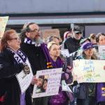 Protesters gather at the Alaska State Capitol on Wednesday, March 12, 2025. Jamie Liston holds a sign that says family is everything. (Jasz Garrett / Juneau Empire)
