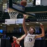 Metlakatlas Carter Marsden lays a shot off the glass over Chevaks Anthony Martins (21) in the Chiefs 63-33 win over the Comets in the 2025 ASAA March Madness Alaska 1A/2A State Basketball Championships on Thursday at Anchorages Alaska Airlines Center (Klas Stolpe / Juneau Empire)