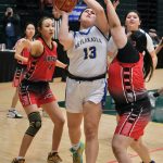 Metlakatlas Baileigh Nelson (13) scores against Chevaks Laney Green (14) and Darcy Umugak during the MisChiefs 34-30 loss to the Comets in the 2025 ASAA March Madness Alaska 2A State Basketball Championships on Thursday at Anchorages Alaska Airlines Center (Klas Stolpe / Juneau Empire)