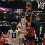 Metlakatlas Brody Booth scores over Chevaks Anthony Martins (21) in the Chiefs 63-33 win over the Comets in the 2025 ASAA March Madness Alaska 1A/2A State Basketball Championships on Thursday at Anchorages Alaska Airlines Center (Klas Stolpe / Juneau Empire)