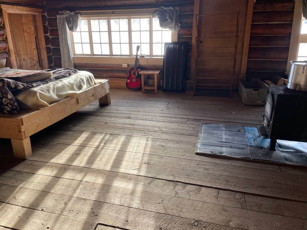 Sun shines on an interior floor of Tolovana Roadhouse, a hospitality stop in the 2025 Iditarod sled dog race. (Photo by Ned Rozell)