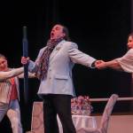 Gabriel von Eisenstein (David Cangelosi) is pulled in two separate directions by his wife Rosalinda (Sara Radke Brown, right) and Rosalindas maid, Adele (Kayla Kohlhase, left) during a dress rehearsal of Die Fledermaus on Wednesday, March 12, 2025. (Jasz Garrett / Juneau Empire)