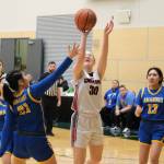 Klawocks Alli Demmert (30) scores over Nunamiuts Eileen Panigeo (21) during the Chieftains 53-25 win over the Amaguqs in the 2025 ASAA March Madness Alaska 1A State Basketball Championships Thursday at Anchorages Alaska Airlines Center. (Klas Stolpe / Juneau Empire)