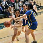 Klawocks Jayla Edenshaw (11) drives against Nunamiuts Asialuk Woods (13) during the Chieftains 53-25 win over the Amaguqs in the 2025 ASAA March Madness Alaska 1A State Basketball Championships Thursday at Anchorages Alaska Airlines Center. (Klas Stolpe / Juneau Empire)