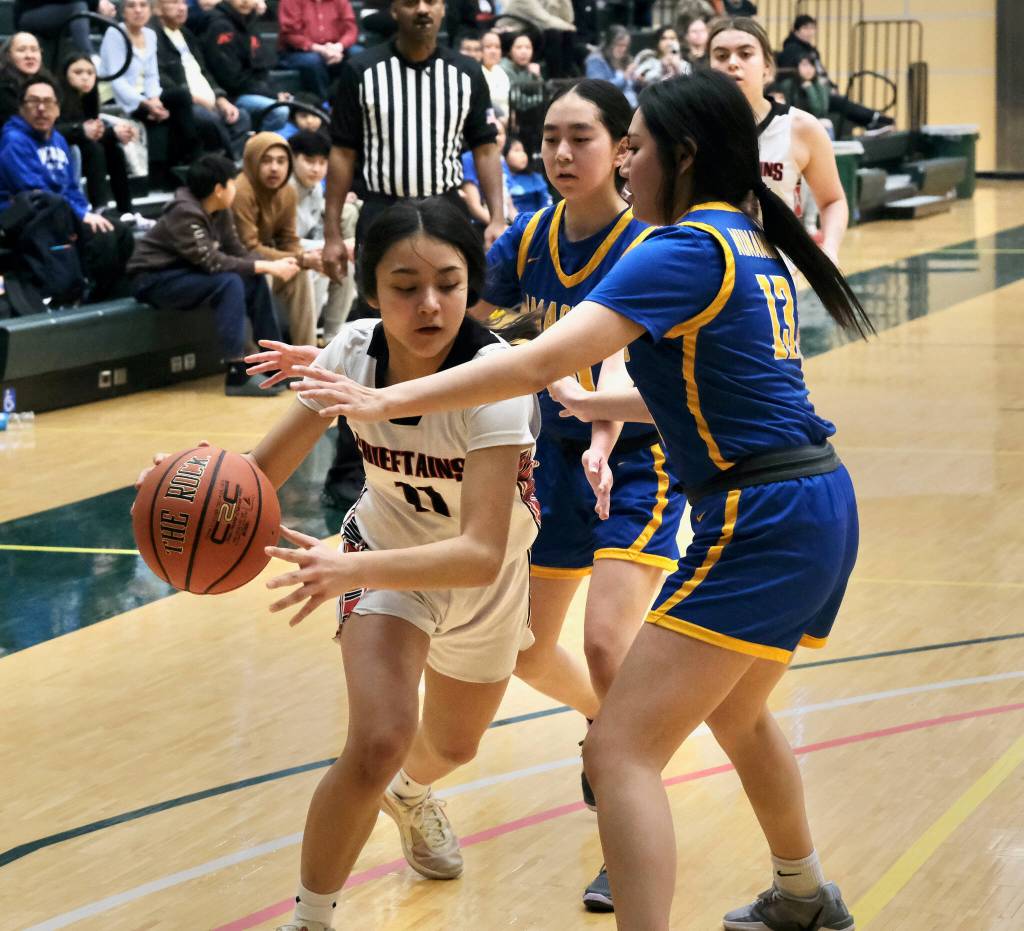 Klawocks Jayla Edenshaw (11) drives against Nunamiuts Asialuk Woods (13) during the Chieftains 53-25 win over the Amaguqs in the 2025 ASAA March Madness Alaska 1A State Basketball Championships Thursday at Anchorages Alaska Airlines Center. (Klas Stolpe / Juneau Empire)
