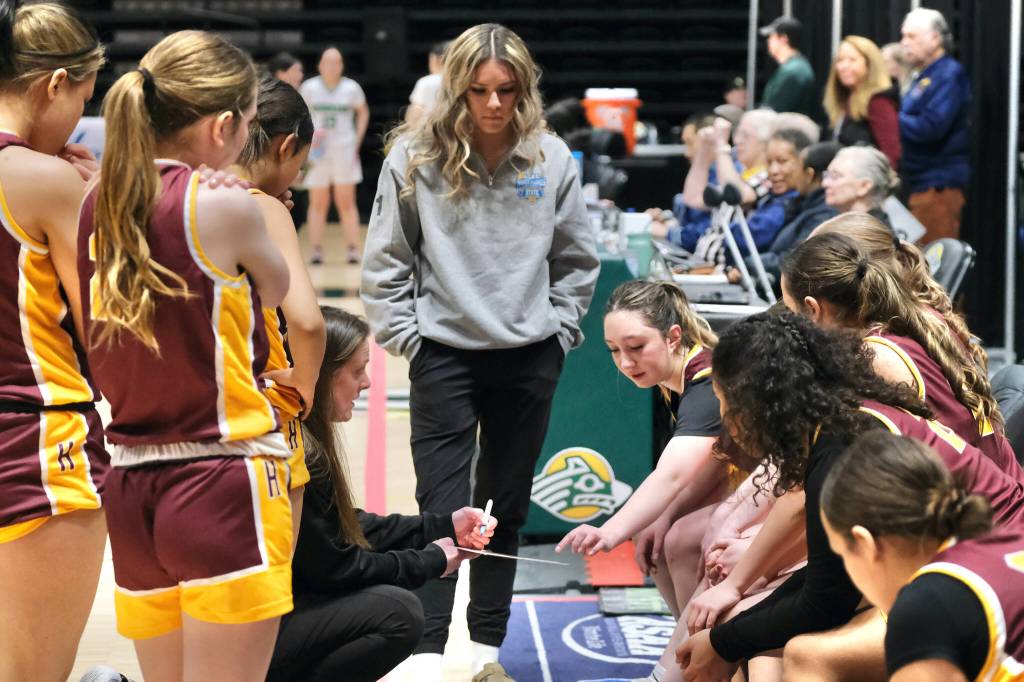 Hoonah coach Marlene Duvall, assistant coach Krista Howland and the Braves design a play in their 43-40 loss to the Shishmaref Northern Lights on Friday in the 2025 ASAA March Madness Alaska 1A State Basketball Championships at Anchorages Alaska Airlines Center (Klas Stolpe / Juneau Empire)