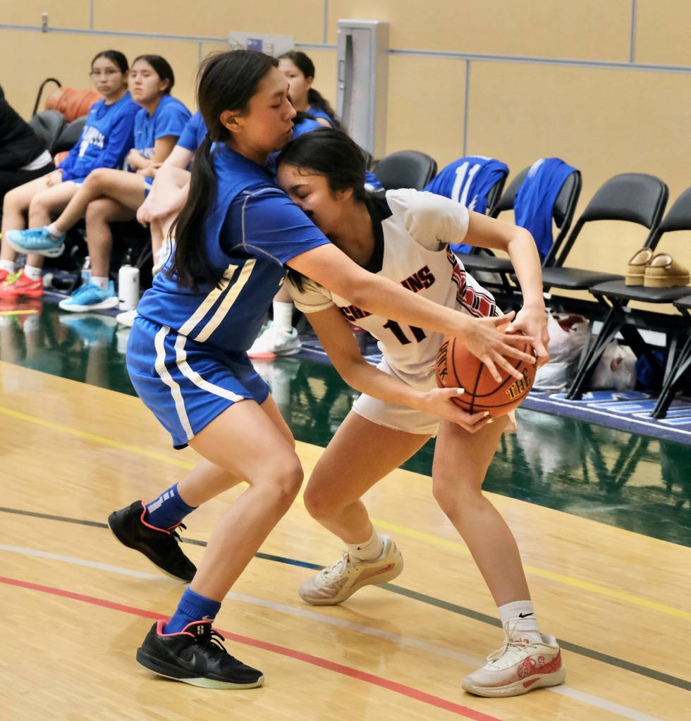 Klawocks Jayla Edenshaw (11) is fouled by Davis Ramoths Brooklyn Hingsbergen during the Chieftains 46-32 loss to the Wolves on Friday in the 2025 ASAA March Madness Alaska 1A State Basketball Championships at Anchorages Alaska Airlines Center (Klas Stolpe / Juneau Empire)