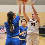 Klawocks Lea Armour (23) scores over Davis Ramoths Zamara Ticket (10) and Calani Hingsbergen-Sheldon (22) during the Chieftains 46-32 loss to the Wolves on Friday in the 2025 ASAA March Madness Alaska 1A State Basketball Championships at Anchorages Alaska Airlines Center (Klas Stolpe / Juneau Empire)