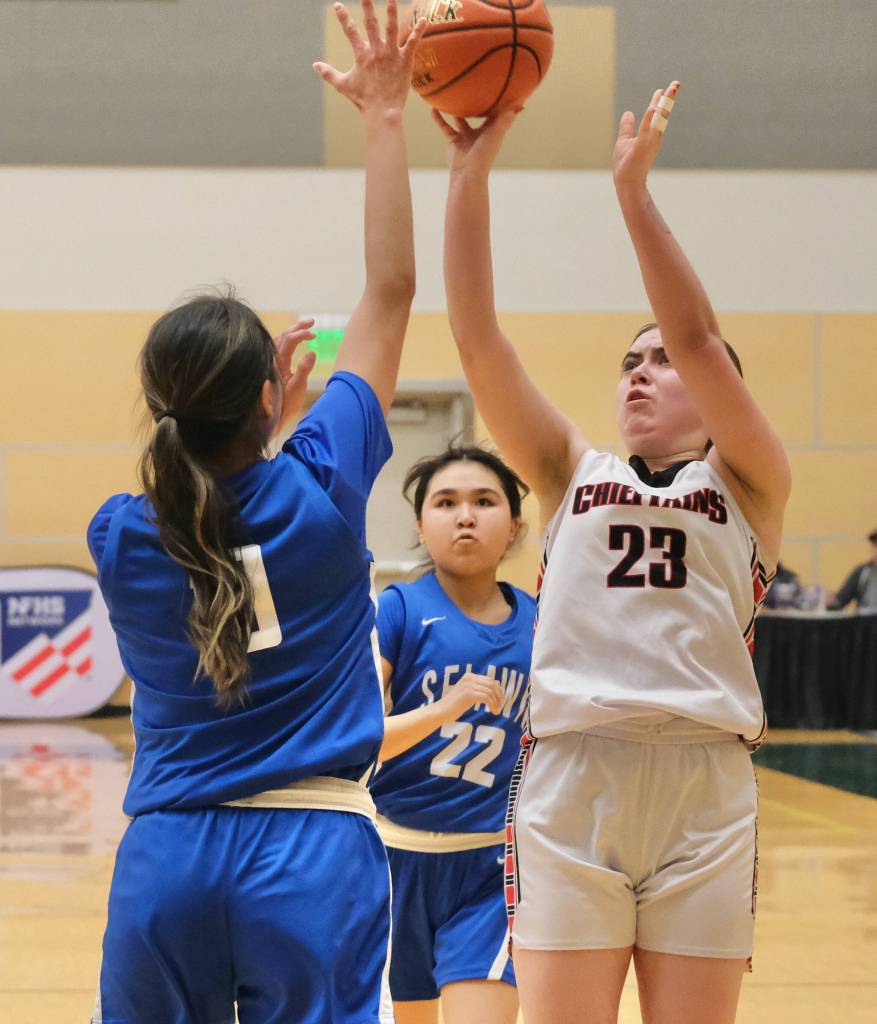 Klawocks Lea Armour (23) scores over Davis Ramoths Zamara Ticket (10) and Calani Hingsbergen-Sheldon (22) during the Chieftains 46-32 loss to the Wolves on Friday in the 2025 ASAA March Madness Alaska 1A State Basketball Championships at Anchorages Alaska Airlines Center (Klas Stolpe / Juneau Empire)