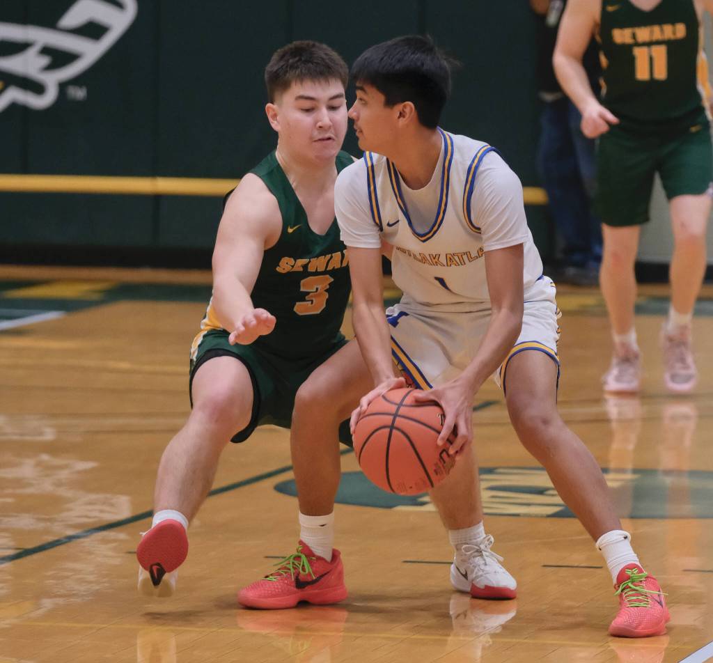 Metlakatla sophomore Gianni Scudero-Hayward (1) is pressured by Seward senior Noah Price (3) during their 3rd/5th-place game Saturday at the 2025 ASAA March Madness Alaska 2A State Basketball Championships at UAAs Avis Sports Center. (Klas Stolpe / Juneau Empire)