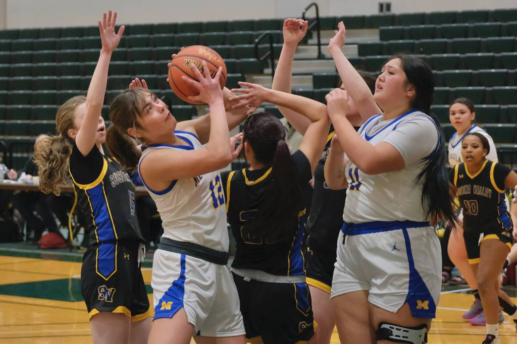Metlakatla senior Lexi Cook (12) grabs a rebound as junior teammate MaKarii Martinez looks on during their 4th/6th-place game against Susitna Valley Saturday at the 2025 ASAA March Madness Alaska 2A State Basketball Championships at UAAs Avis Sports Center. (Klas Stolpe / Juneau Empire)