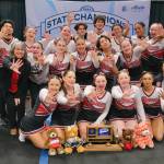 The Juneau-Douglas High School: Yadaa.at Kalé Crimson Bears cheer team pose Tuesday after winning the Division I 2025 ASAA Cheer State Championships at Anchorages Alaska Airlines Center. (Klas Stolpe / Juneau Empire)