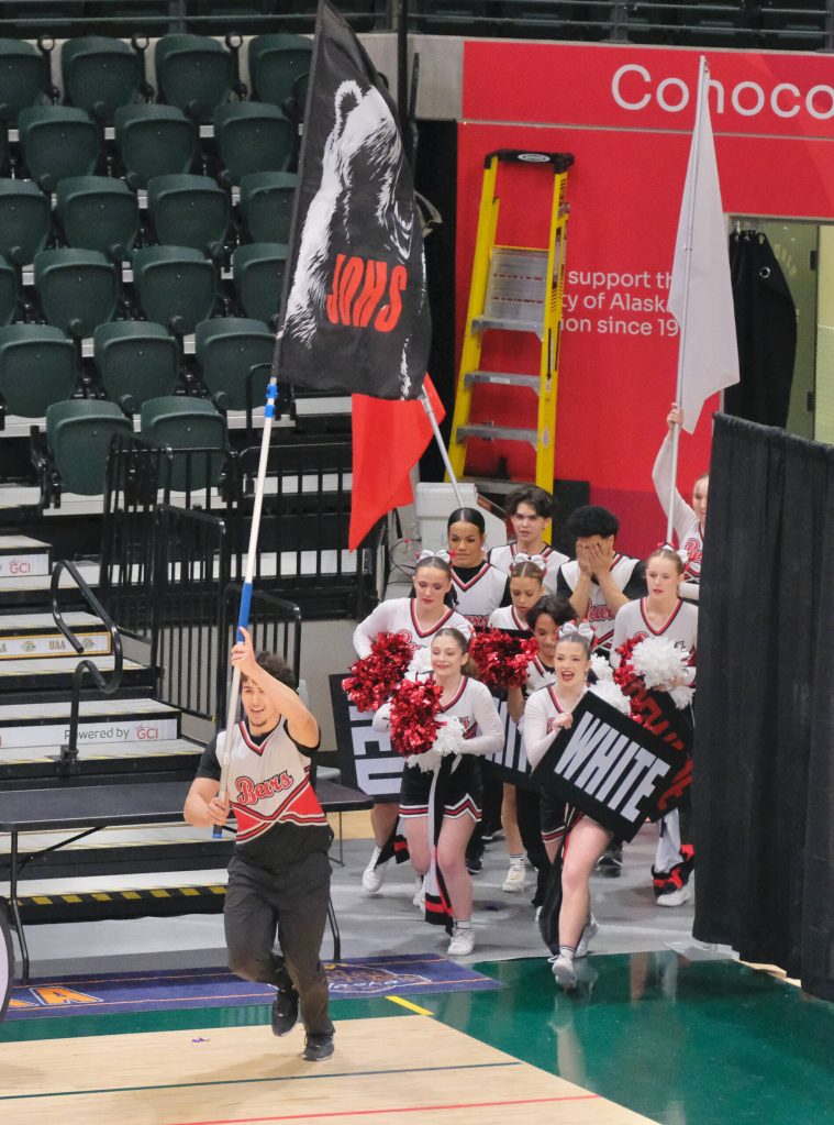 JDHS senior Stefano Rivera leads the Juneau-Douglas High School: Yadaa.at Kalé Crimson Bears cheer team onto the court during the Division I 2025 ASAA Cheer State Championships Tuesday at Anchorages Alaska Airlines Center. (Klas Stolpe / Juneau Empire)