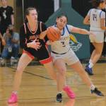 Juneau-Douglas High School: Yadaa.at Kalé senior Kerra Baxter (22) battles for a ball with Bartlett senior Aviana Stoute (3) during the Crimson Bears 49-44 win over the Golden Bears on Wednesday at the 2025 ASAA March Madness Alaska 4A Basketball State Championships at Anchorages Alaska Airlines Center. (Klas Stolpe / Juneau Empire)