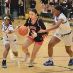 Juneau-Douglas High School: Yadaa.at Kalé senior Addison Wilson (10) secures a ball under pressure from Bartlett freshmen Kennedi Gaines (1) and Nahliah Houston (4) during the Crimson Bears
