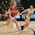 Sitka senior Marina Dill dribbles under pressure from Grace Christian junior Molly Schild (12) Wednesday in the 2025 ASAA March Madness Alaska 3A/4A Basketball State Championships at Anchorages Alaska Airlines Center. (Klas Stolpe / Juneau Empire)