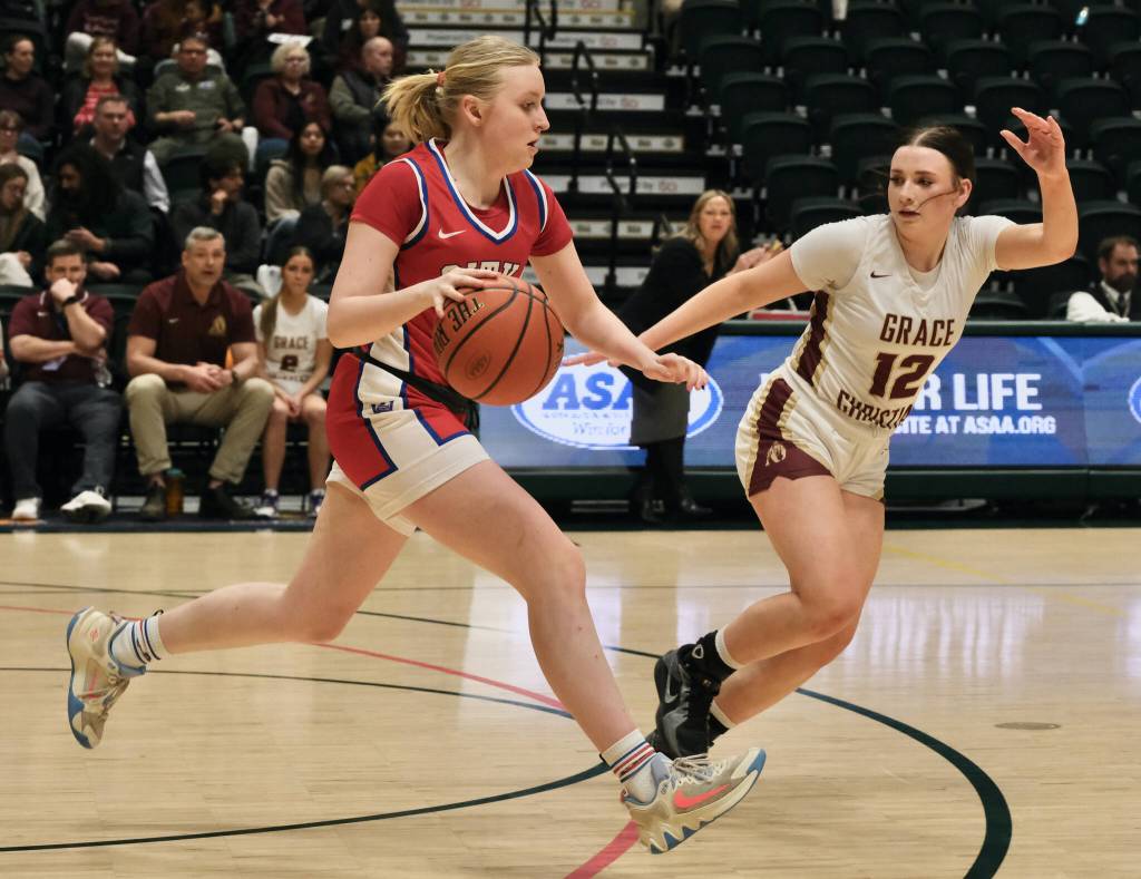 Sitka senior Marina Dill dribbles under pressure from Grace Christian junior Molly Schild (12) Wednesday in the 2025 ASAA March Madness Alaska 3A/4A Basketball State Championships at Anchorages Alaska Airlines Center. (Klas Stolpe / Juneau Empire)