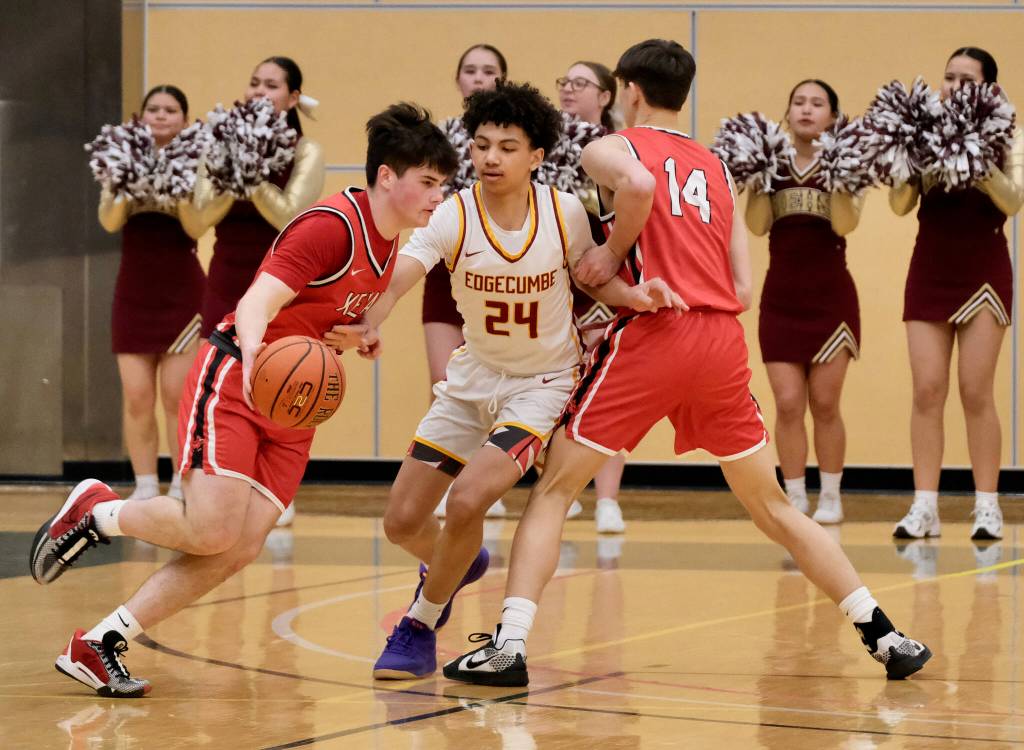 Kenai sophomore Garrett McCanna dribbles around a screen by classmate Miles Metteer (14) as Mt. Edgecumbe sophomore Xavier Gundersen (24) defends Wednesday in the 2025 ASAA March Madness Alaska 3A/4A Basketball State Championships at Anchorages Alaska Airlines Center. (Klas Stolpe / Juneau Empire)
