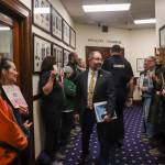 Sen. Jesse Kiehl (D-Juneau) greets protesters of U.S. Sen. Dan Sullivan (R-Alaska) prior to his address to the Alaska Legislature on Thursday, March 20, 2025. (Jasz Garrett / Juneau Empire)
