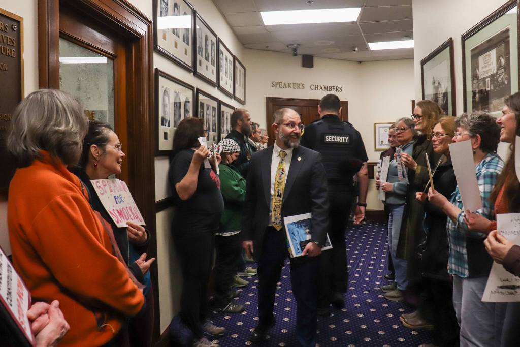 Sen. Jesse Kiehl (D-Juneau) greets protesters of U.S. Sen. Dan Sullivan (R-Alaska) prior to his address to the Alaska Legislature on Thursday, March 20, 2025. (Jasz Garrett / Juneau Empire)
